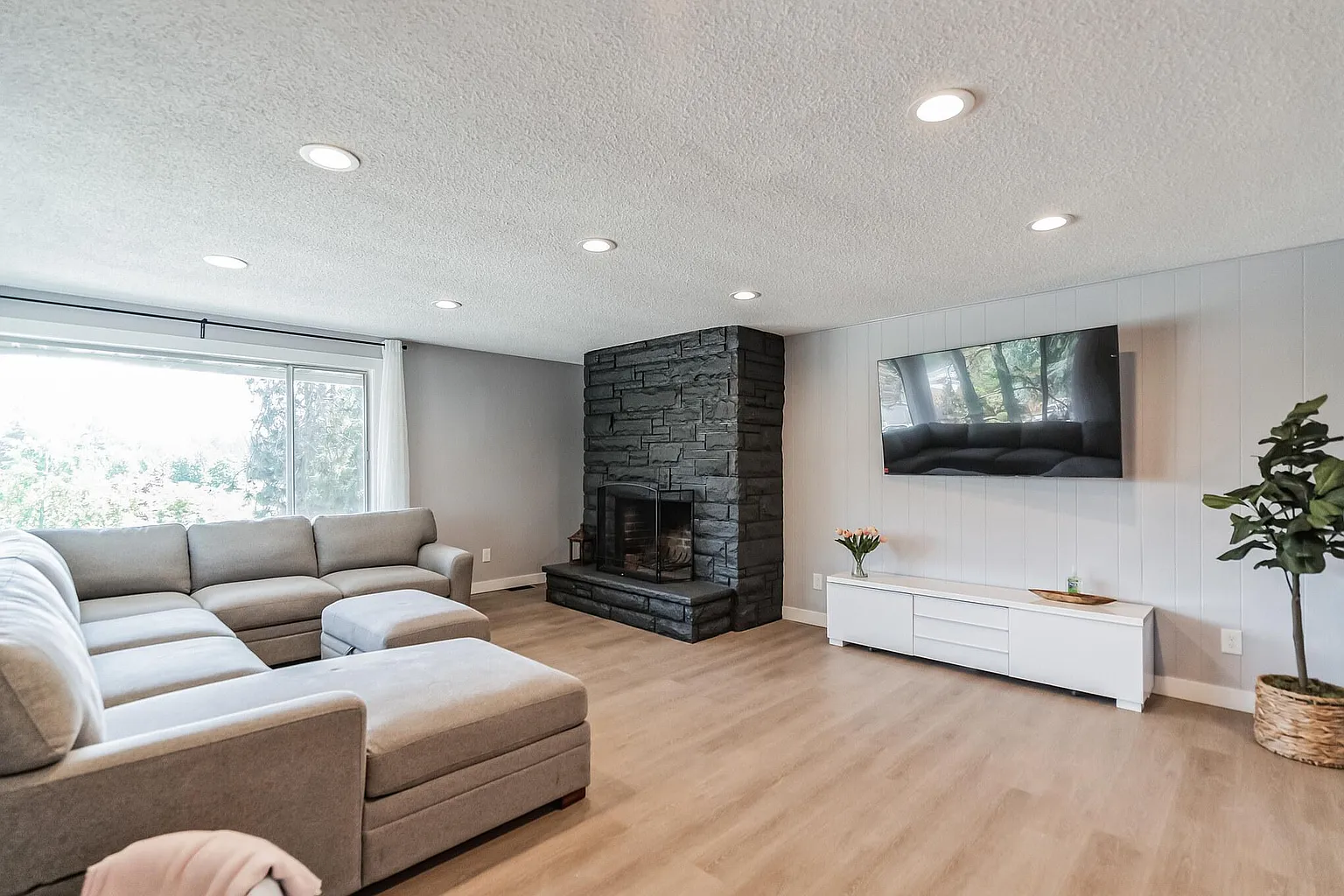 Living room with stone fireplace at Oregon Sober Homes sober living Gladstone Oregon